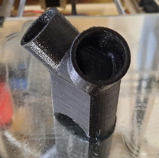 Photo of adapter sitting on 3D printer glass bed